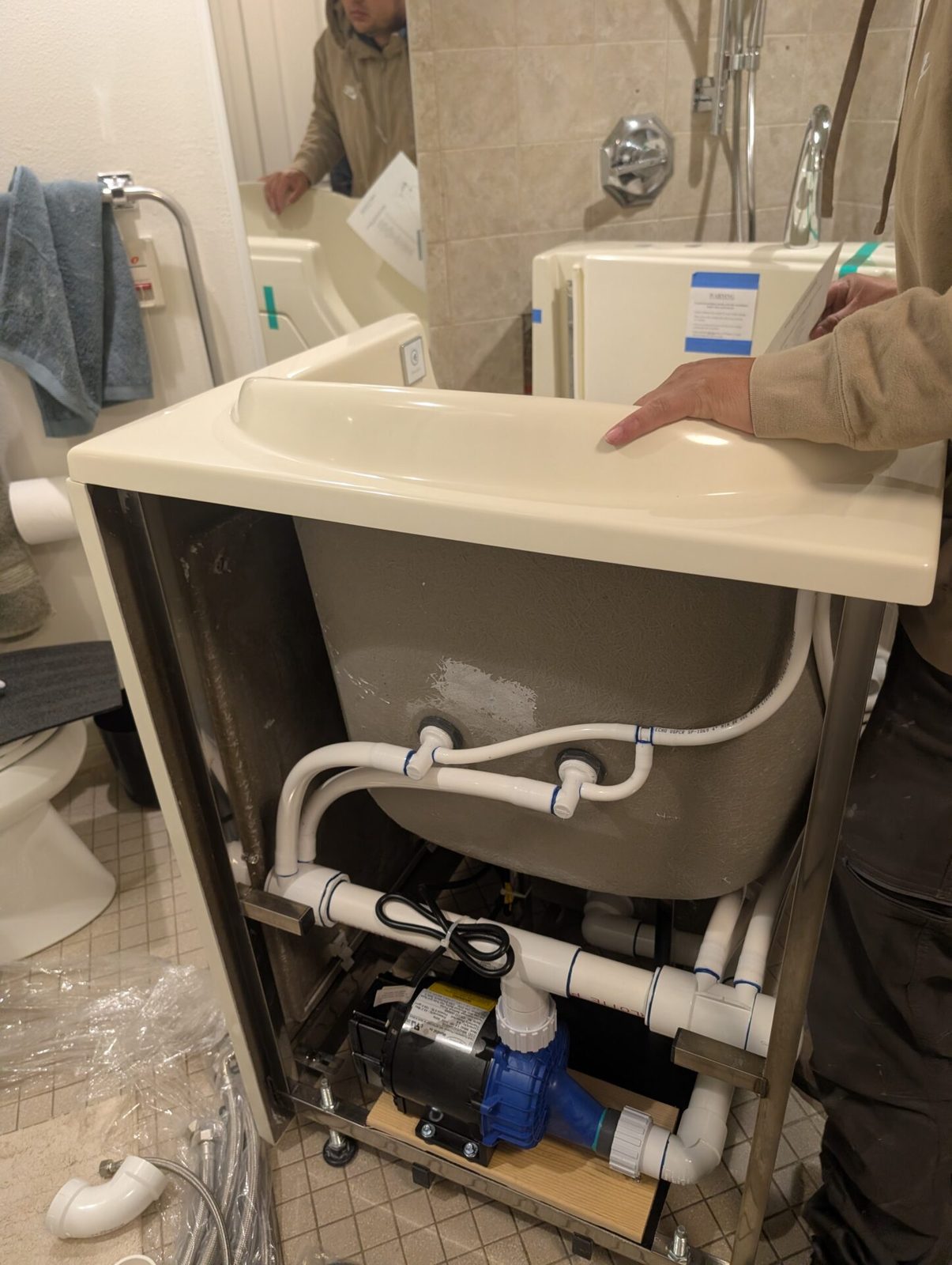 Installing senior low entry bathtub updating bathroom.